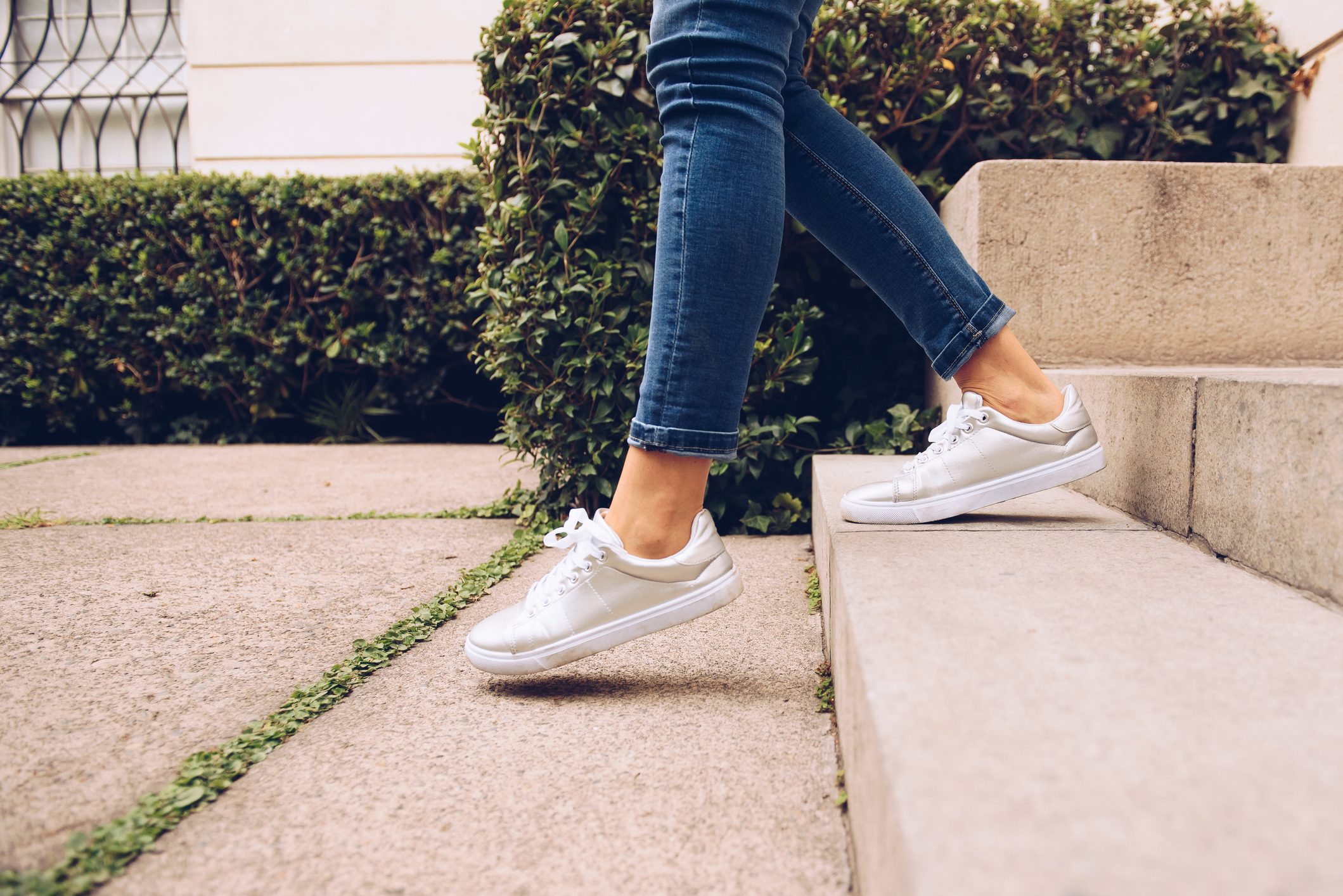 side view of woman walking down stairs outside