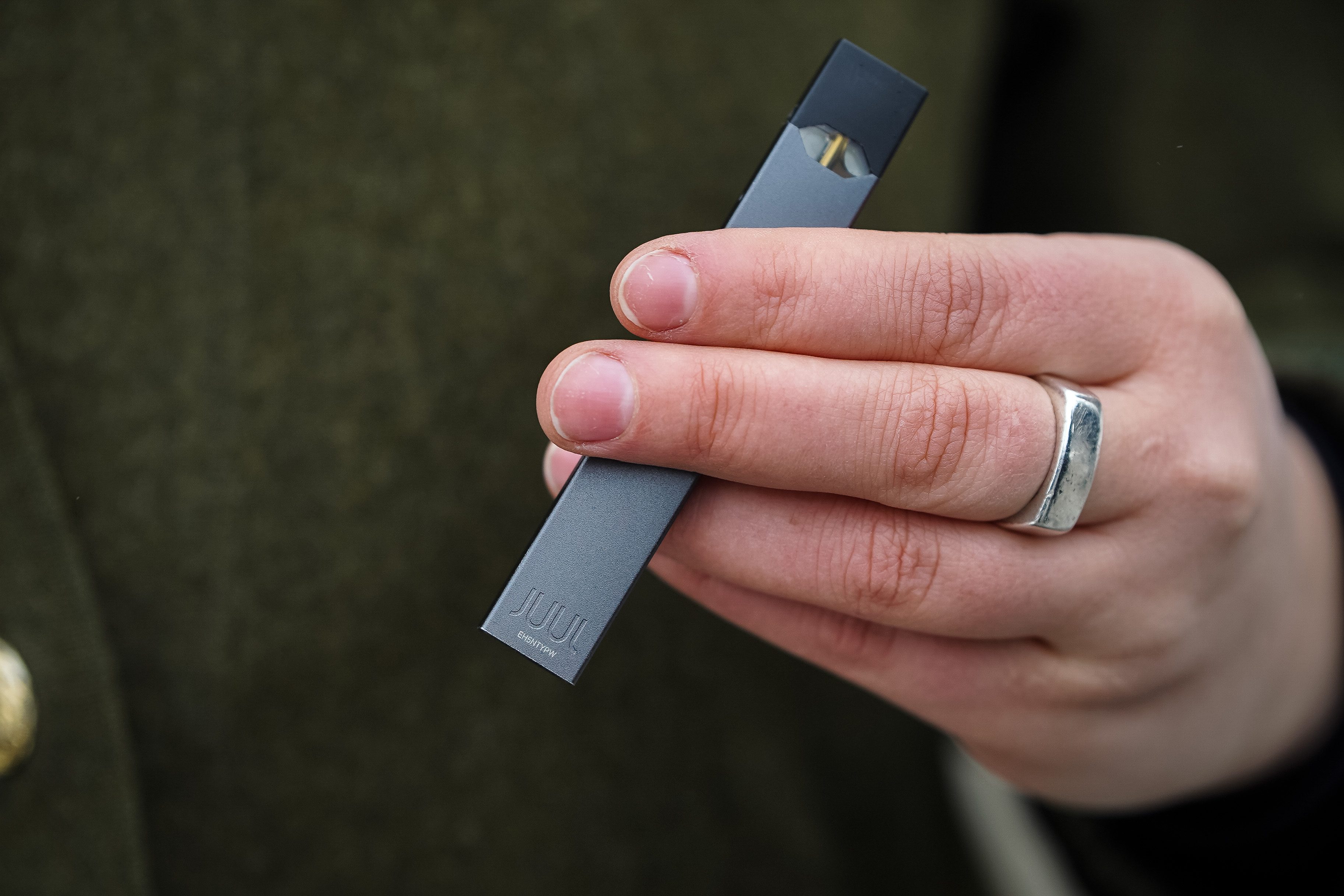 Woman holding Juul e-cig