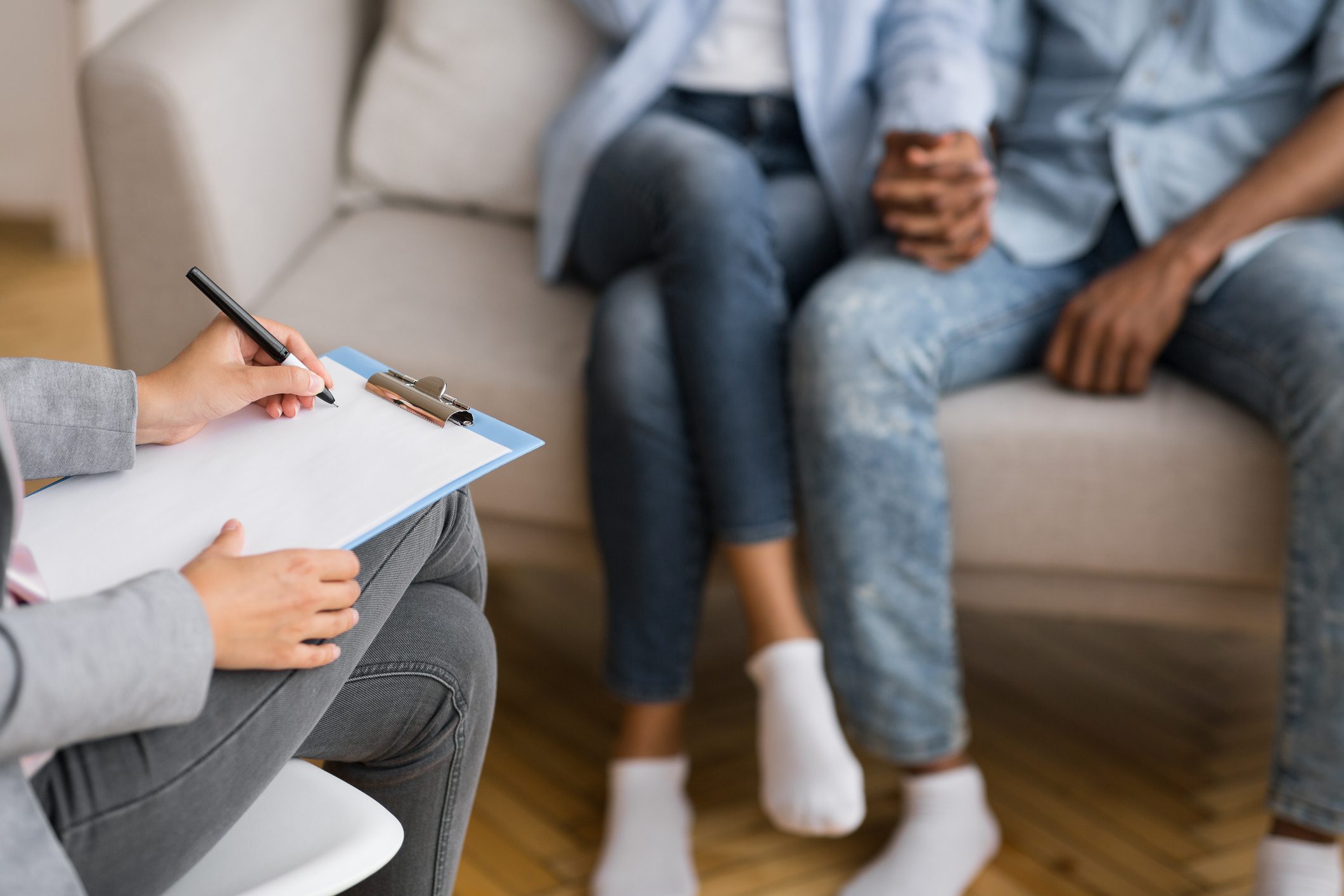 Unrecognizable Husband And Wife Holding Hands During Marital Therapy