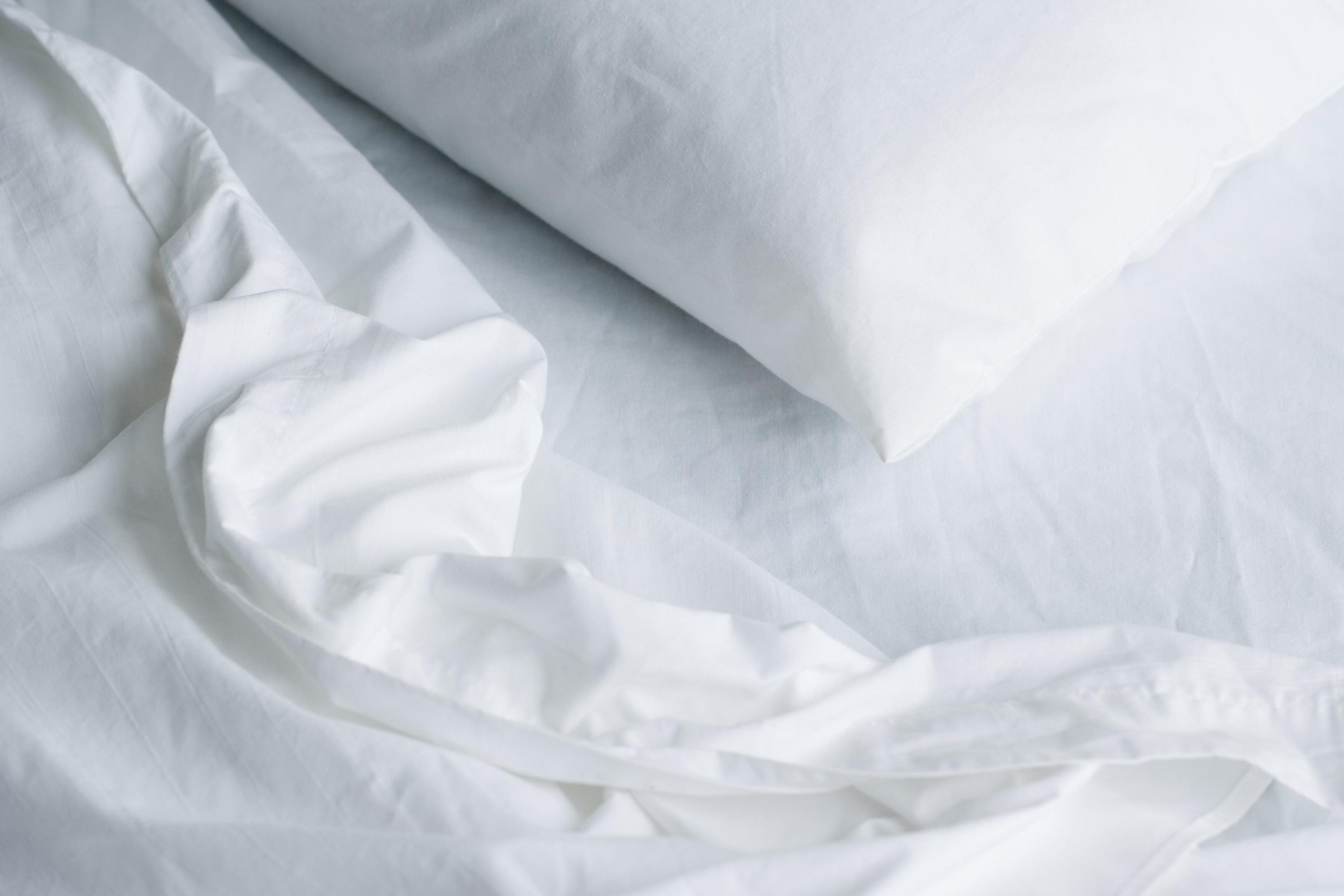 Still life of pillow and bed sheets