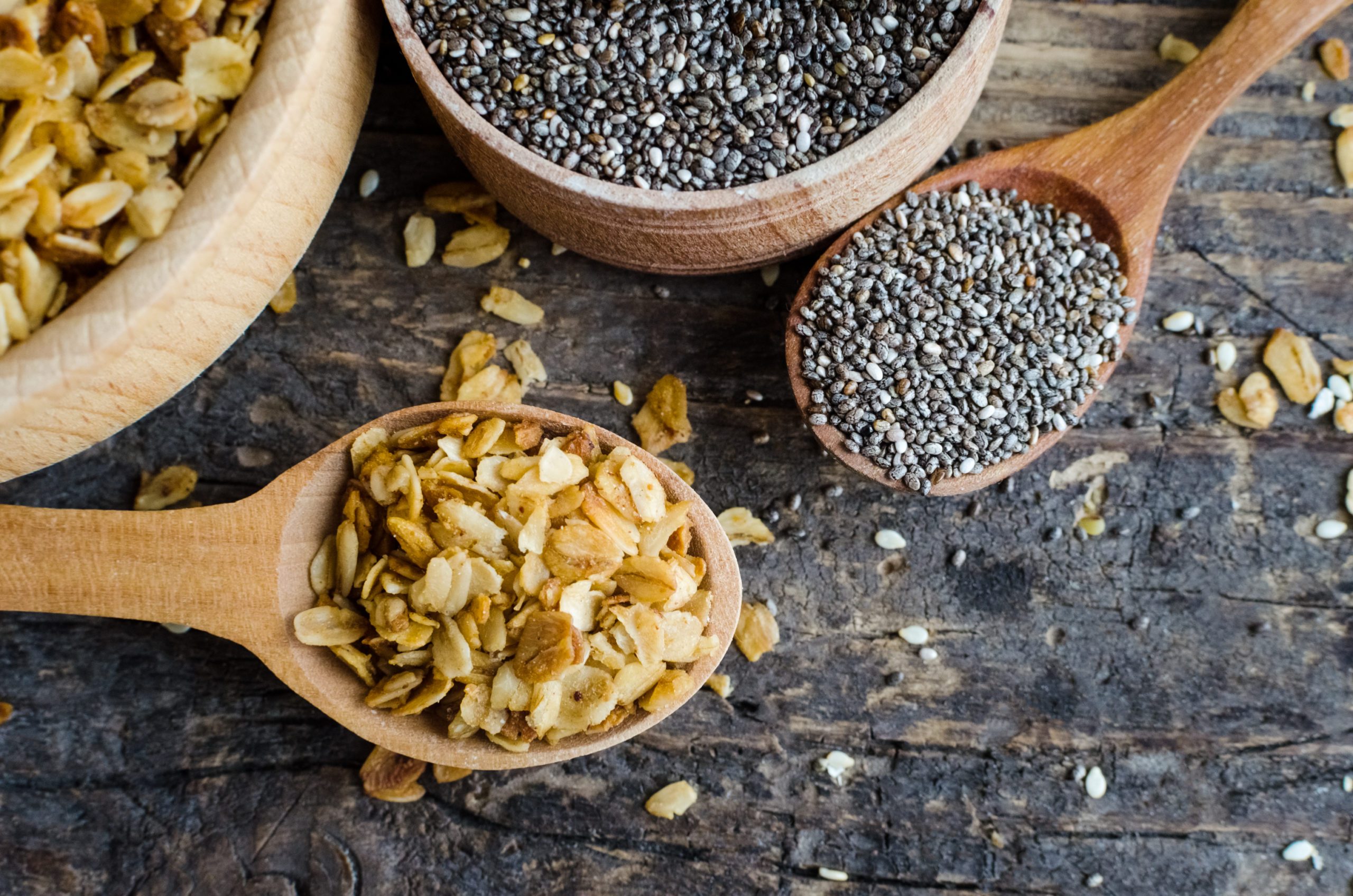 chia seeds and oats in wooden spoons