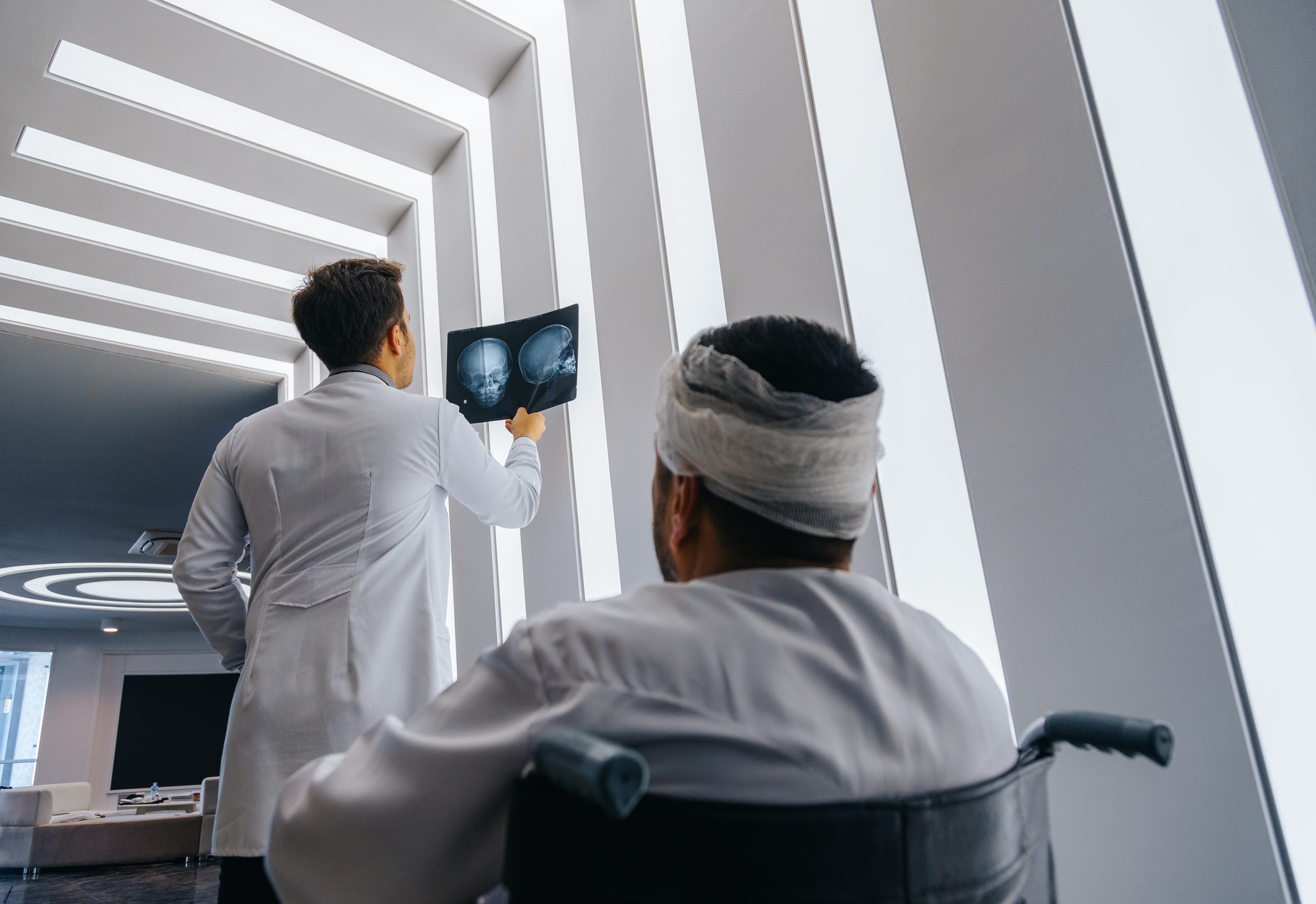 Young doctor man looking x-ray of the patient's skull