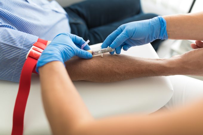 Doctor taking blood