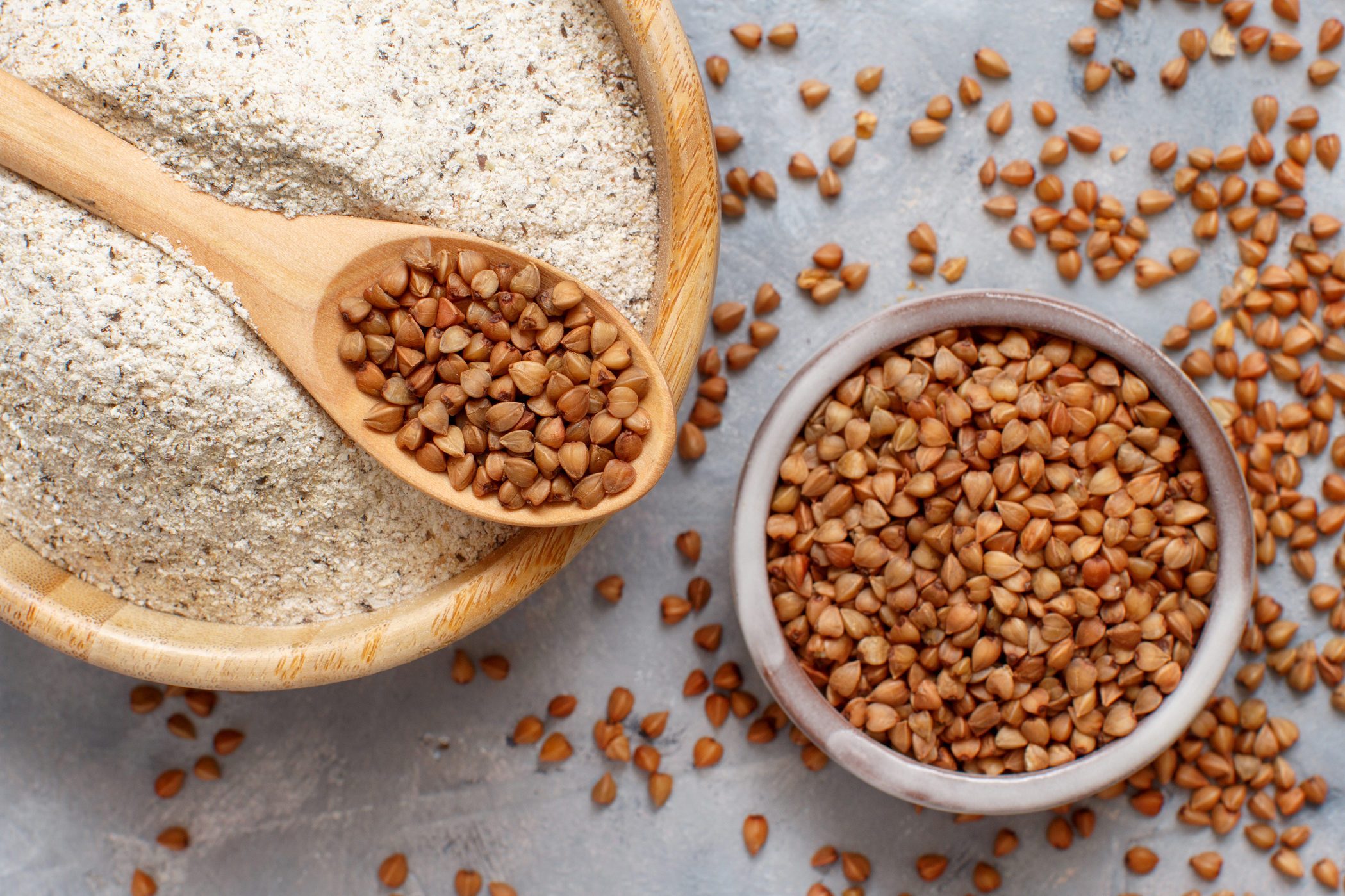 Buckwheat flour in a bowl and buckwheat grain