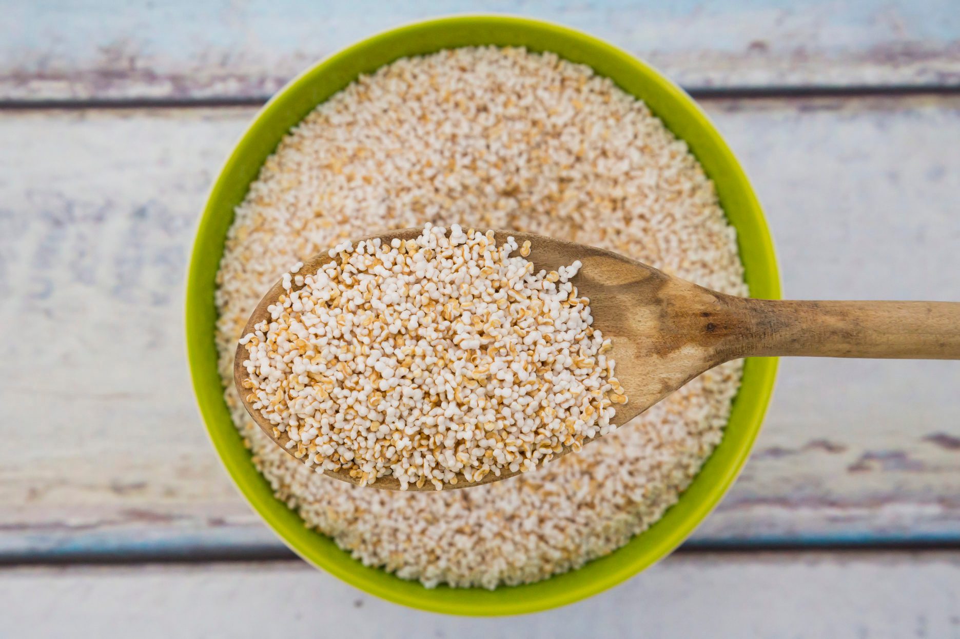 Popped organic amarant on wood spoon and in bowl