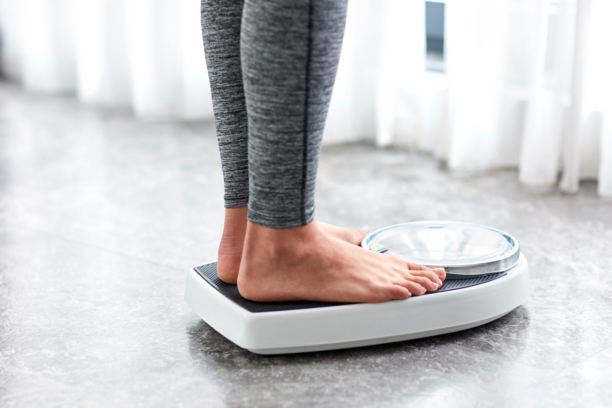 Young Healthy Girl On Home Scales
