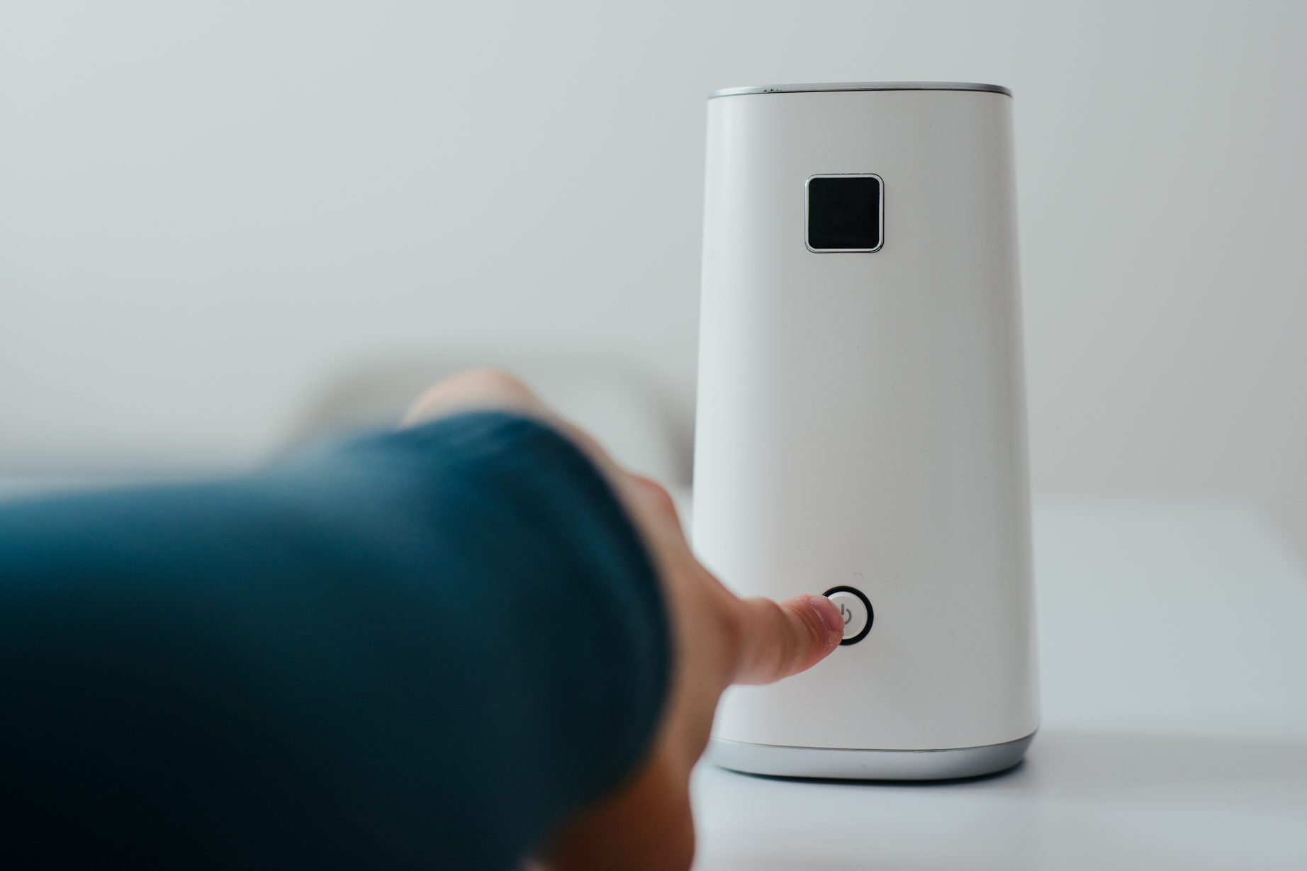White air ionizer on light background. The concept of taking care of the air in the apartment, taking care of the well-being. Air filter.