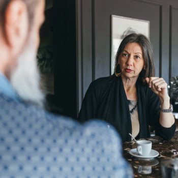 Couple in discussion over coffee in kitchen