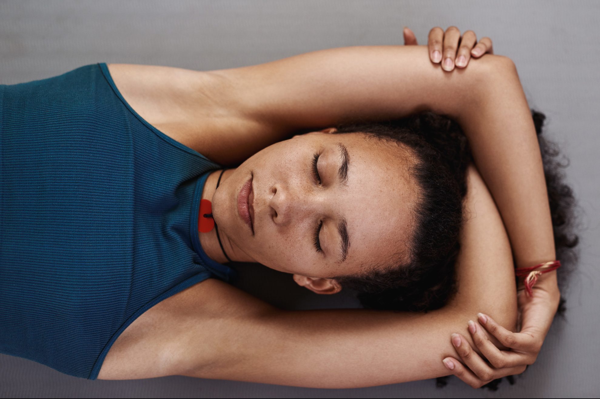 woman lying down meditating shot from above
