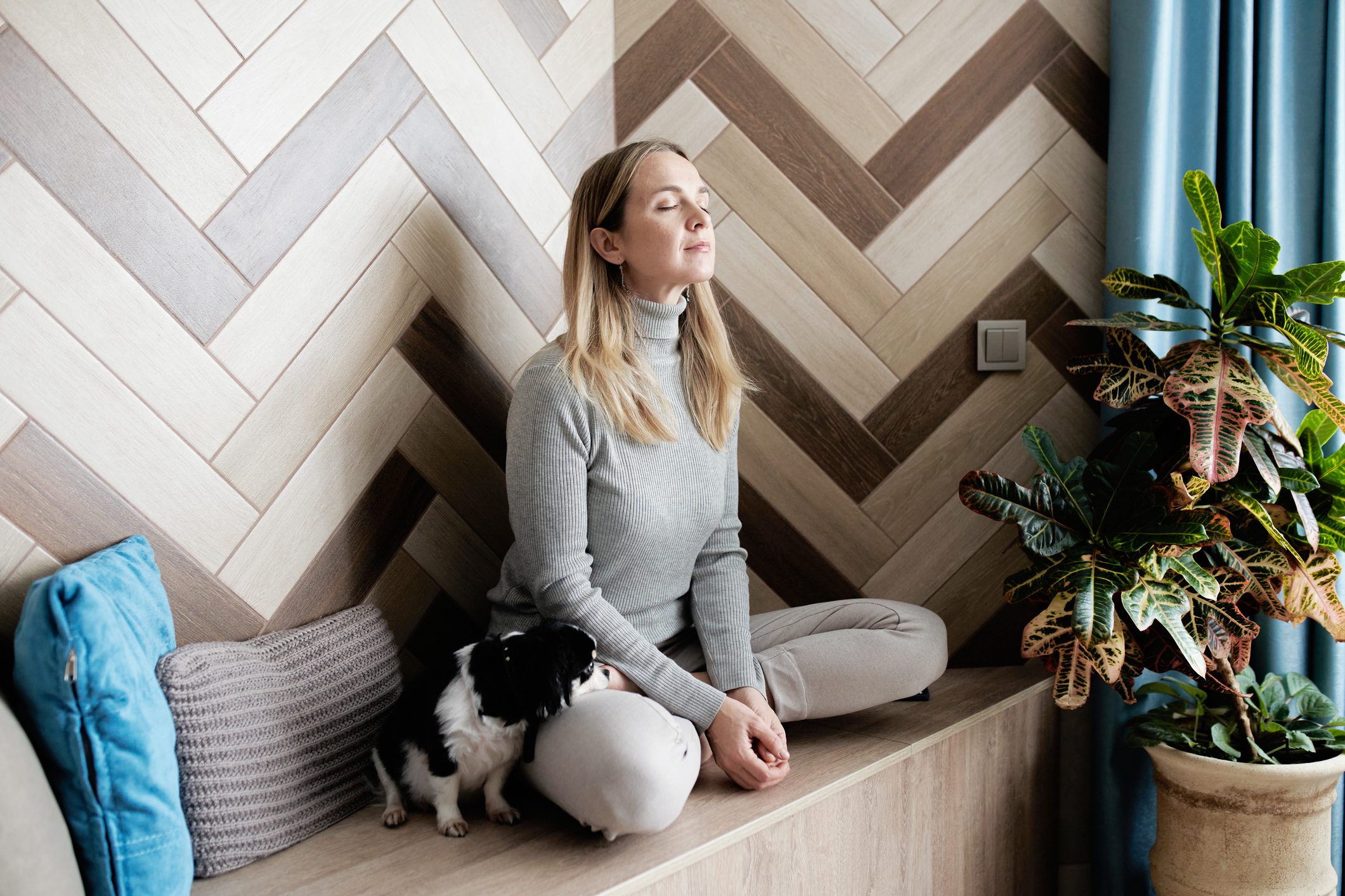 A young woman sits in the Lotus position and meditates