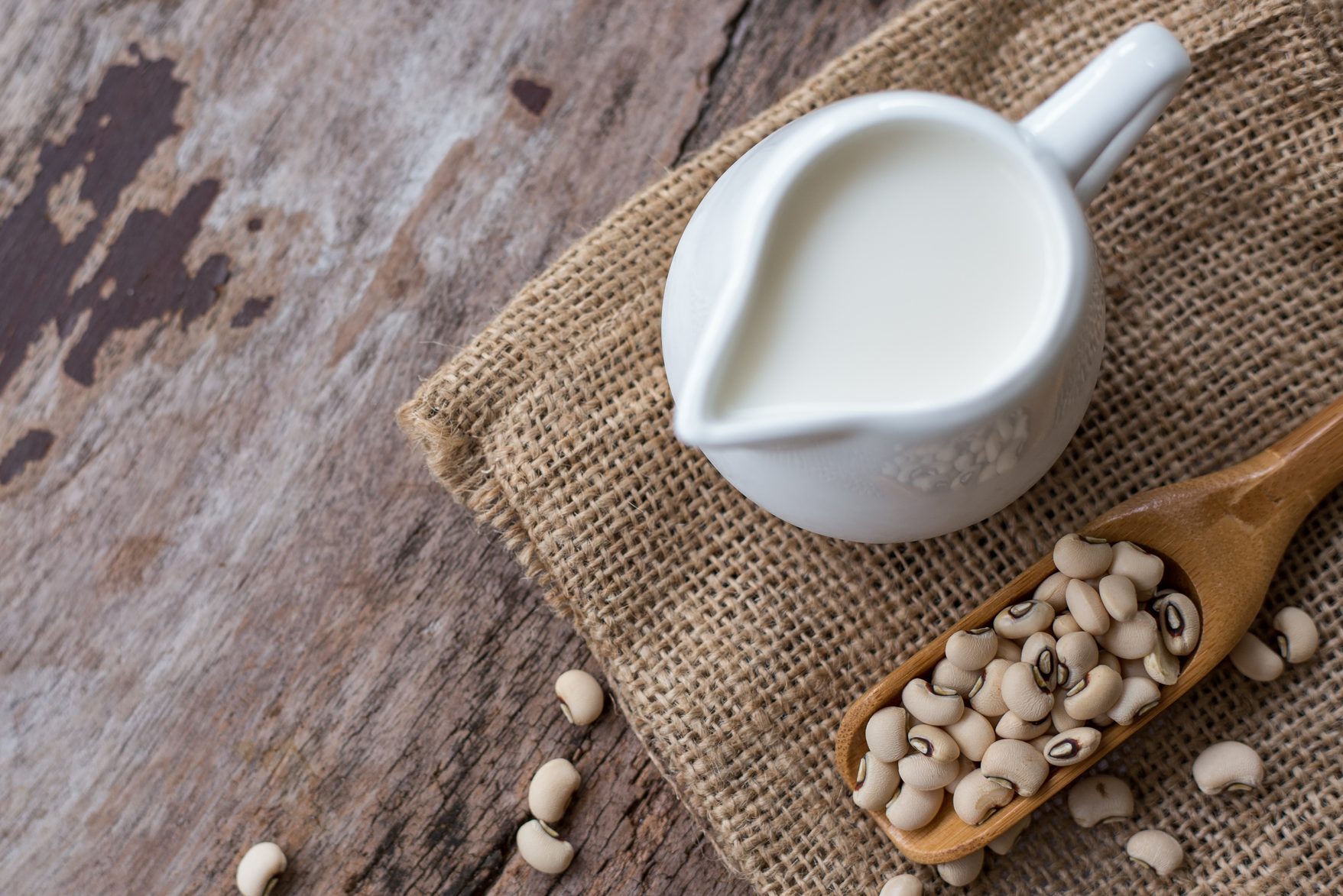 Soy milk and soy bean on wood table