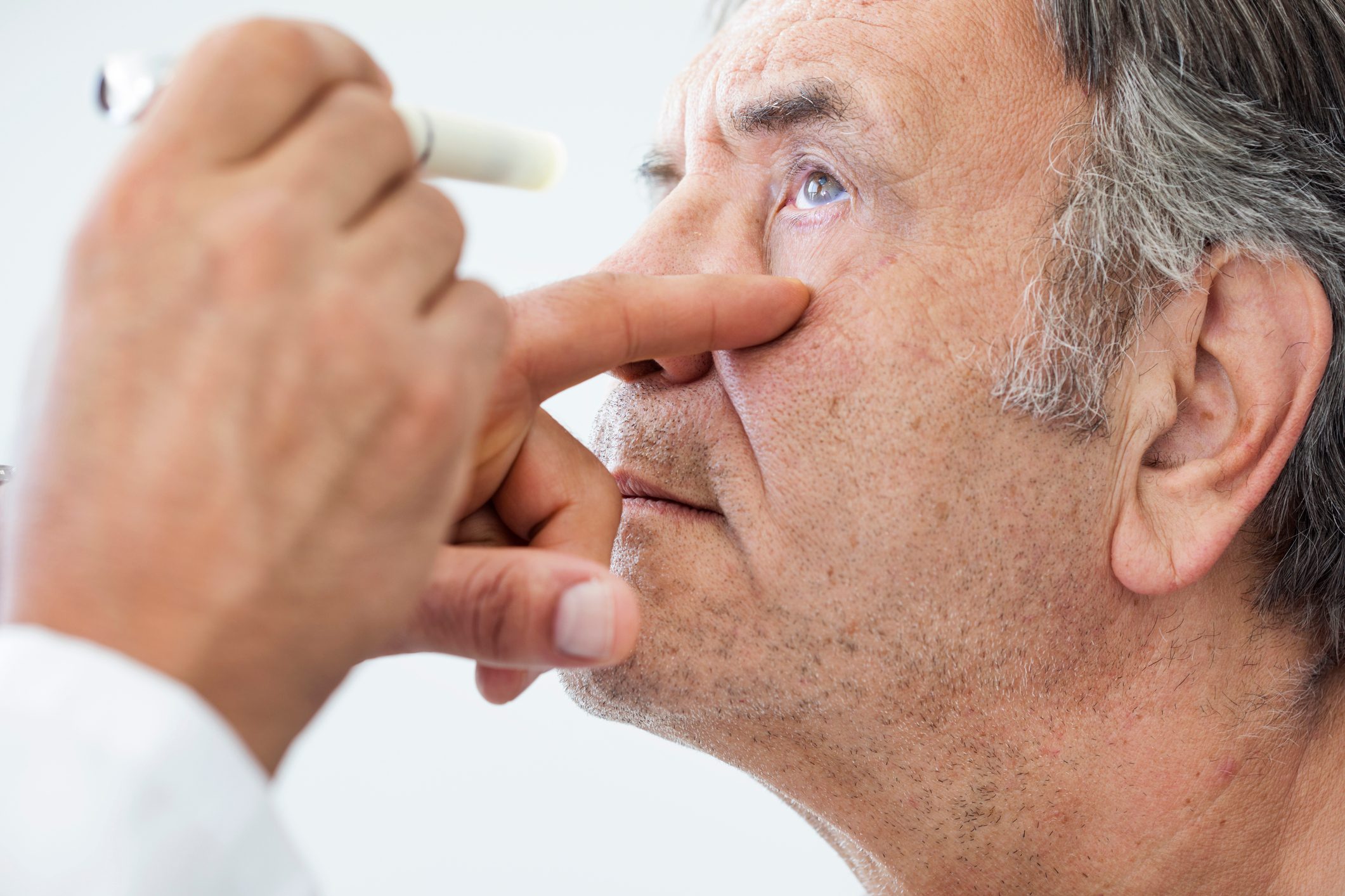 man getting eyes examined by an ophthalmologist