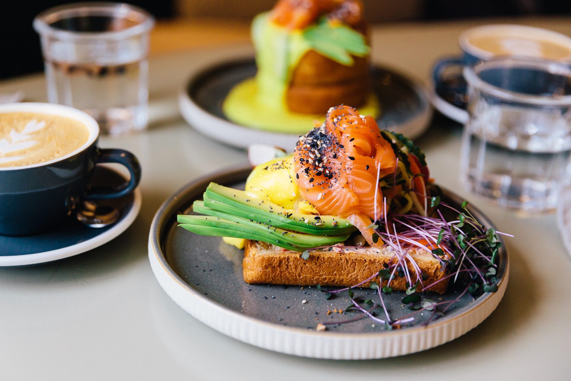 Avocado toast with smoked salmon and poached egg served for breakfast at a cafe