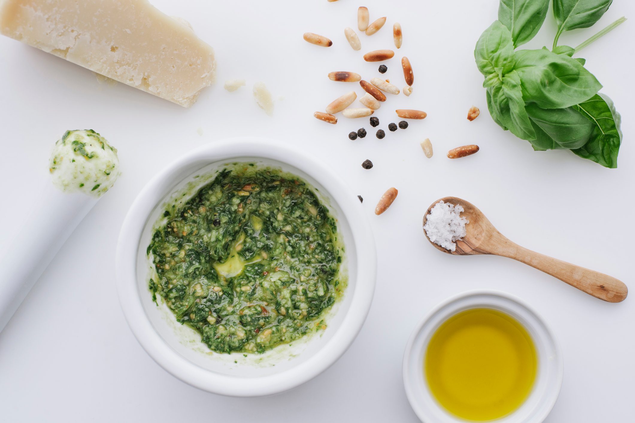 Ingredients for pesto on white ground