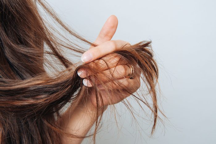 Girl holding her hair in her hand