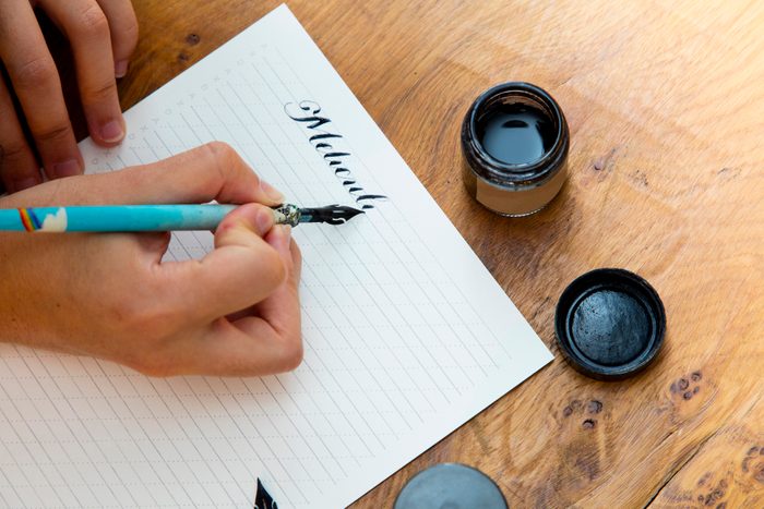Woman writing with calligraphy pen