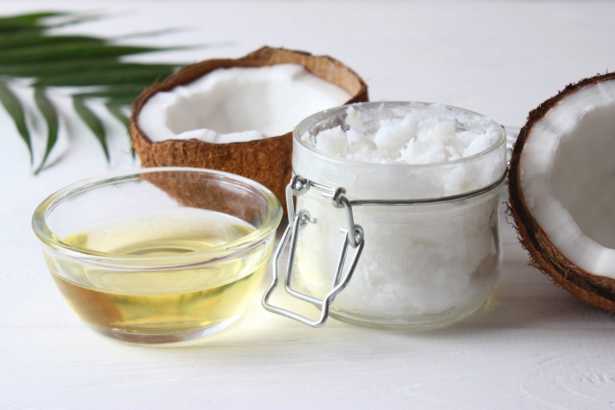 coconut oil and coconuts, palm branches close up