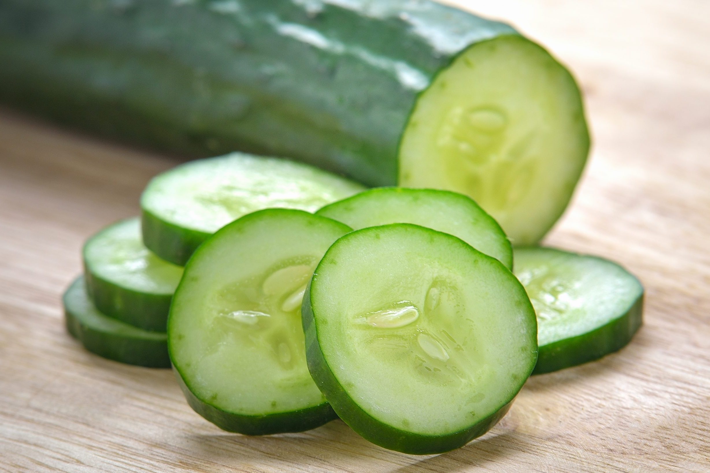 Fresh Cucumber slices on wood background