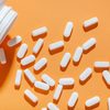 Magnesium capsules on an orange background