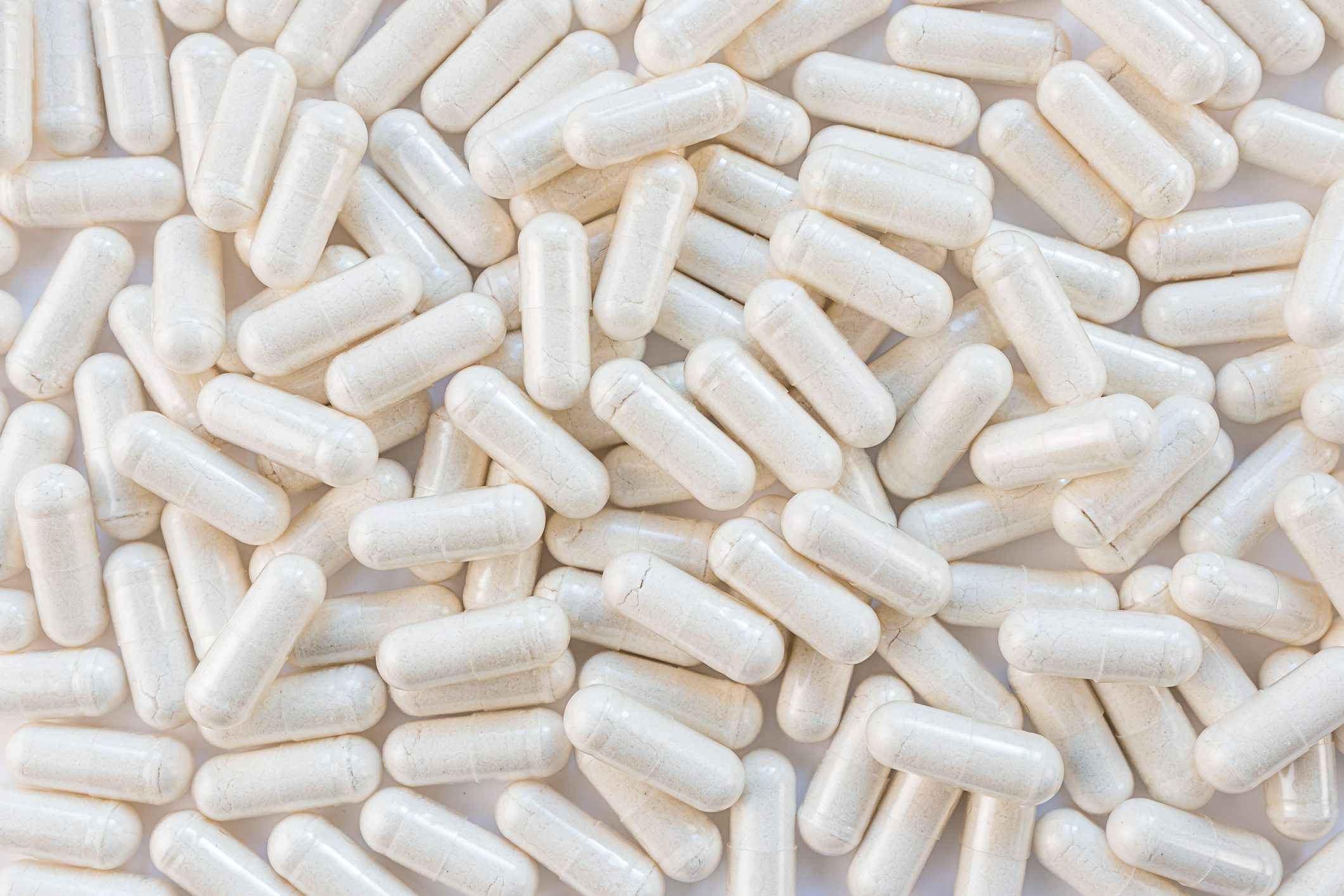 full frame of light colored supplement capsules