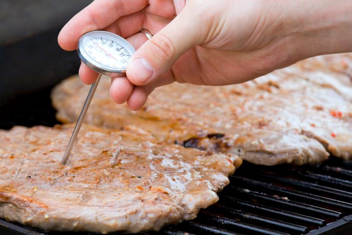 A probe being inserted to check the meat