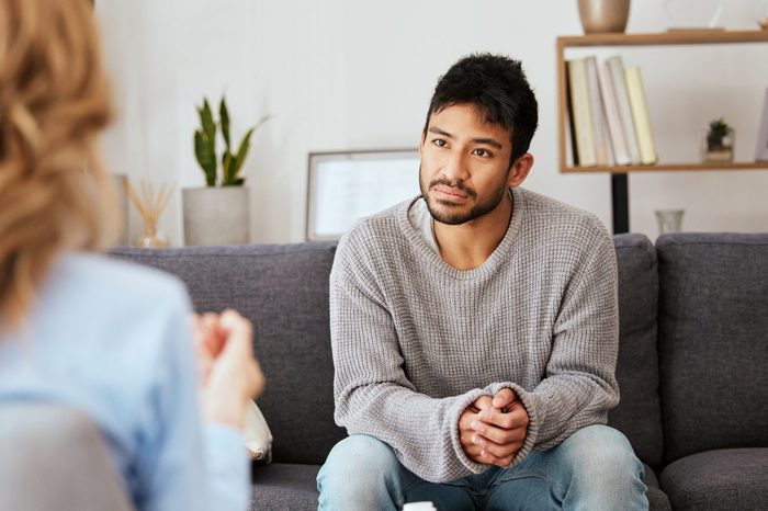 Shot of a young man having a therapeutic session with a psychologist