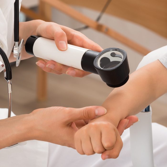 Doctor Examining Skin Of Child Patient