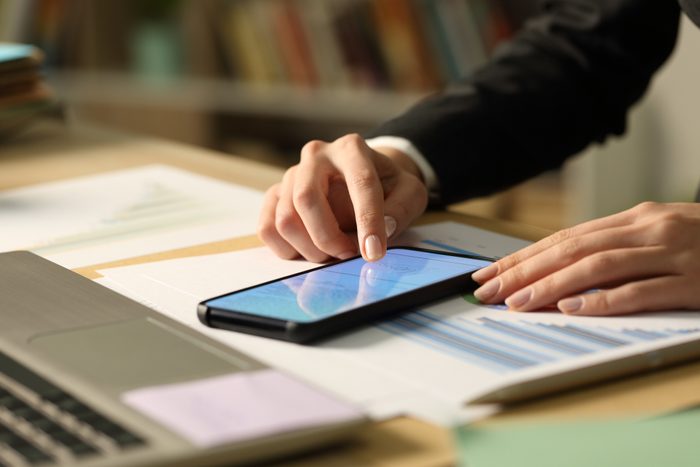 Entrepreneur hands signing contract on phone at night