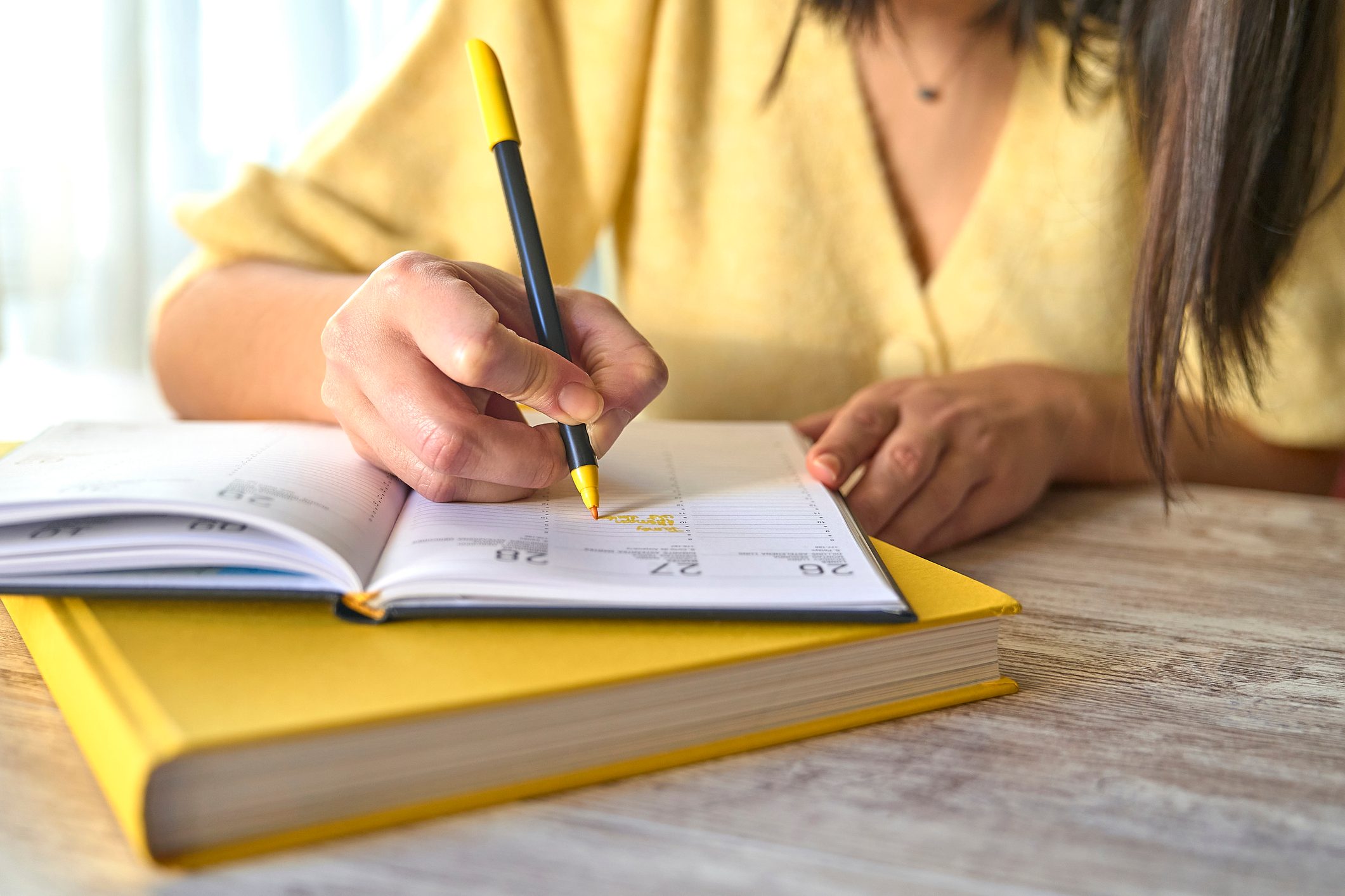 Woman writes on her datebook