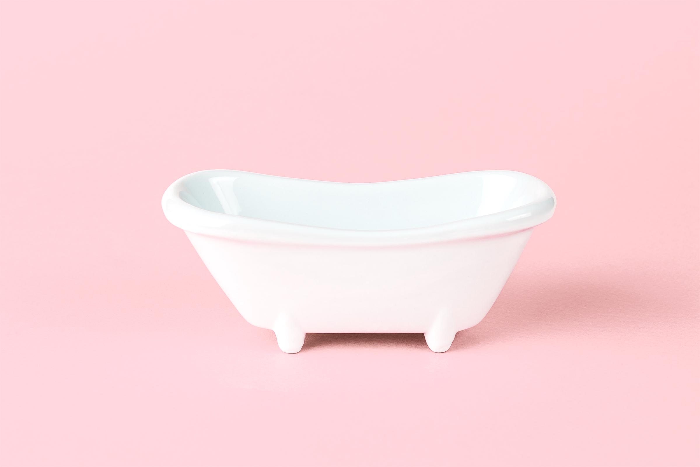 toy bathtub on pink background