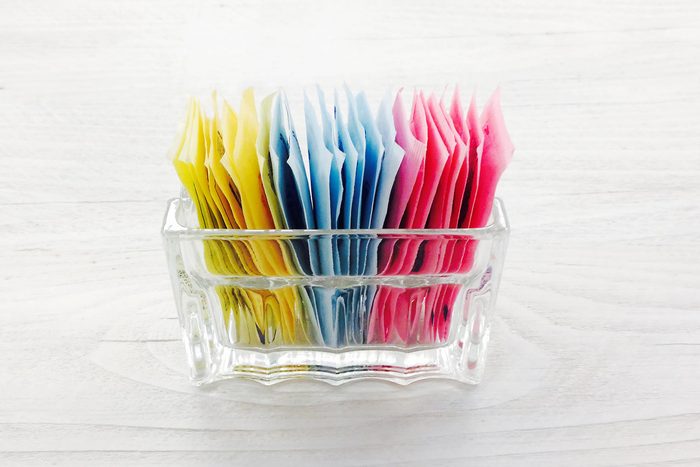 sugar packets in a container at a restaurant