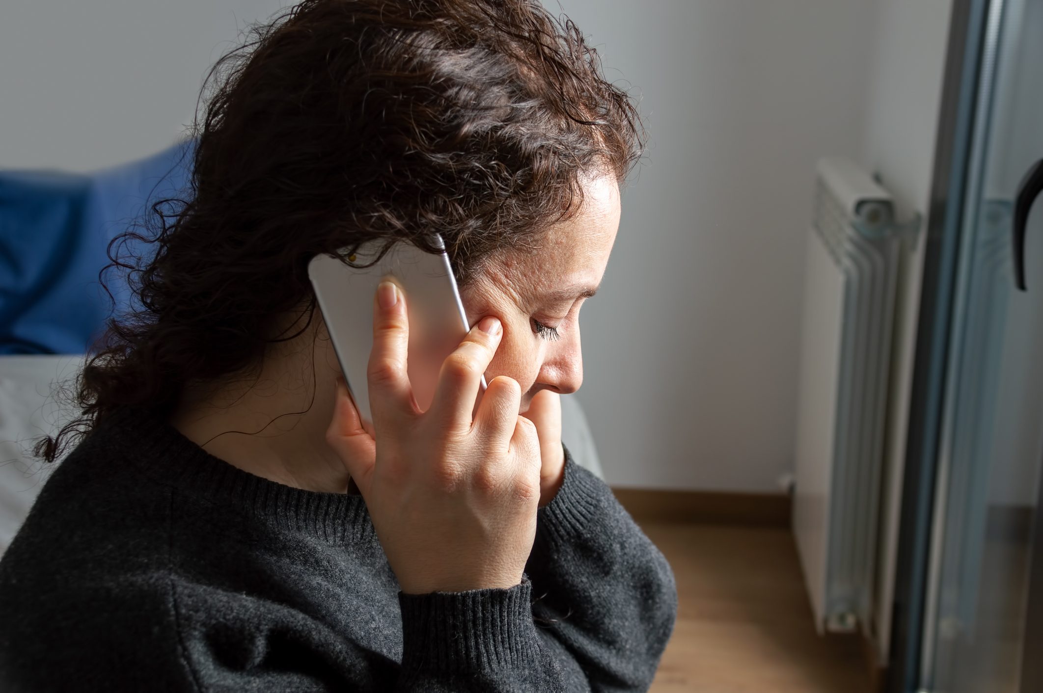sadness woman talking by smartphone