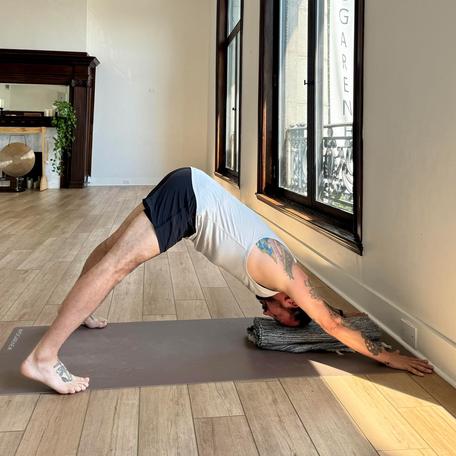 man doing Downward Facing Dog yoga pose