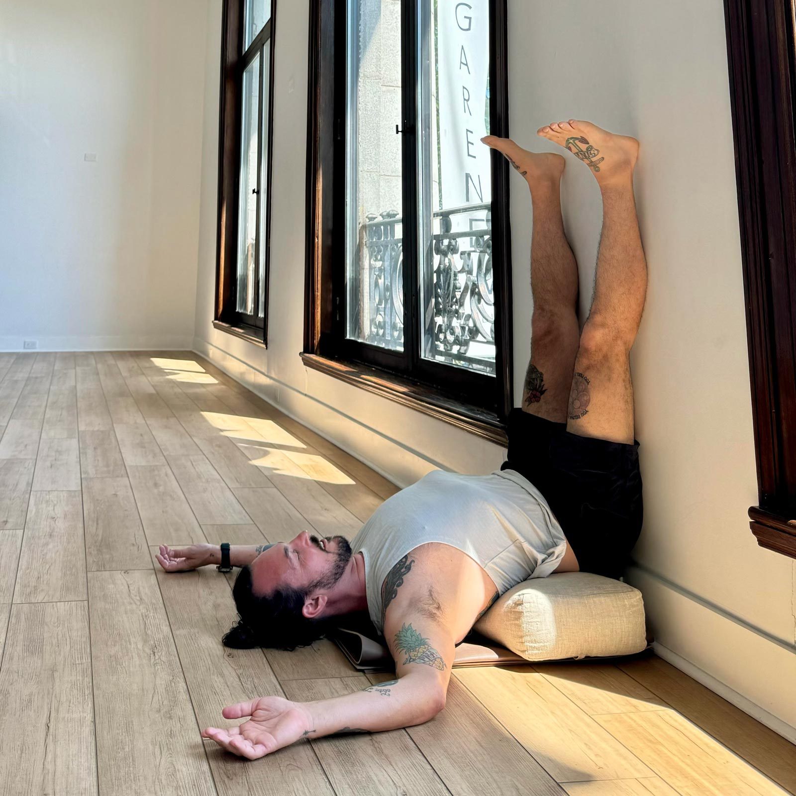 man doing Legs Up The Wall yoga pose