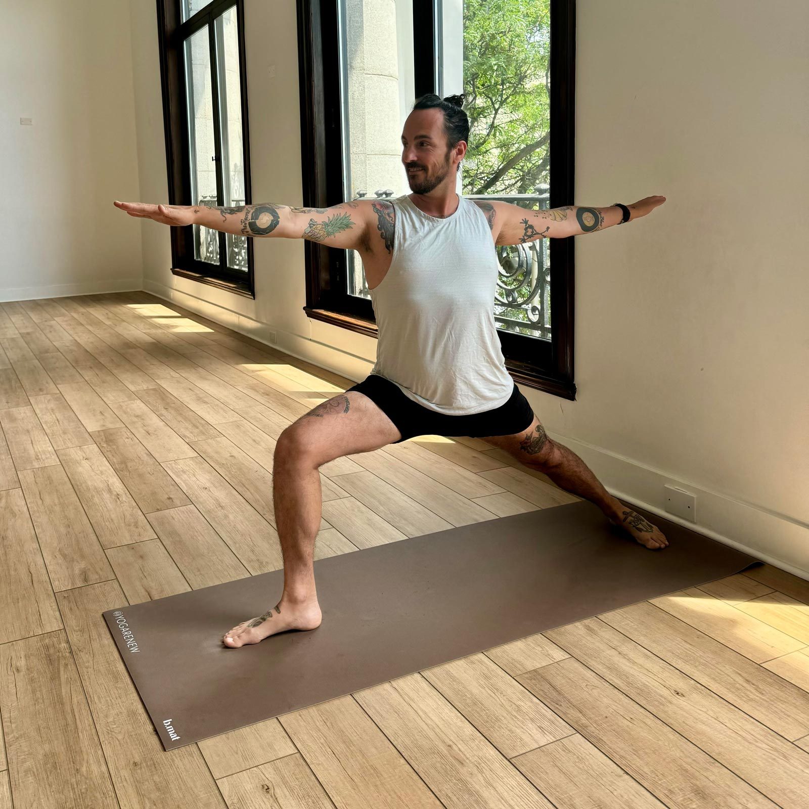 man doing Warrior 2 yoga pose