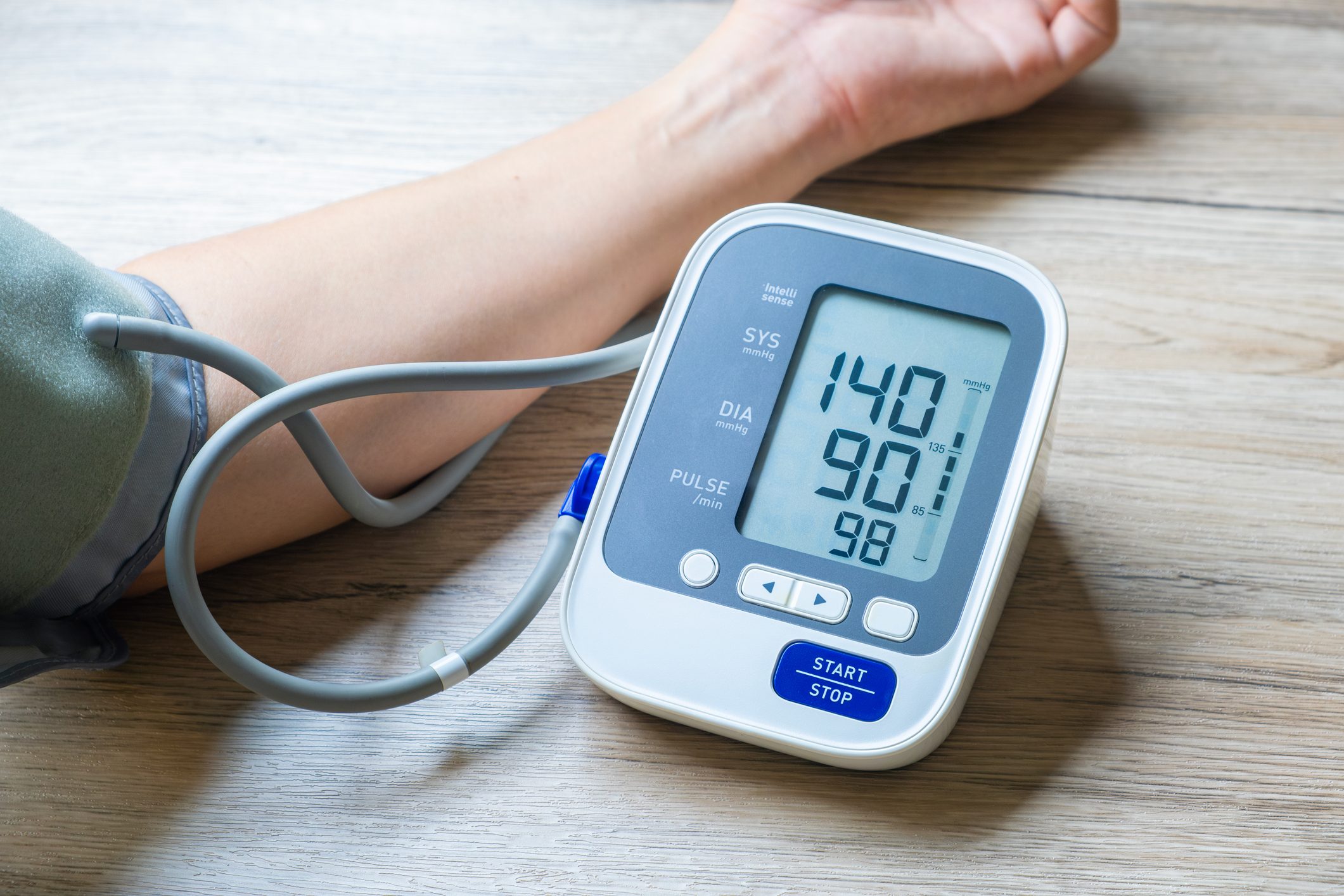 Man checks blood pressure monitor and heart rate monitor with digital pressure gauge. Health care and Medical concept.