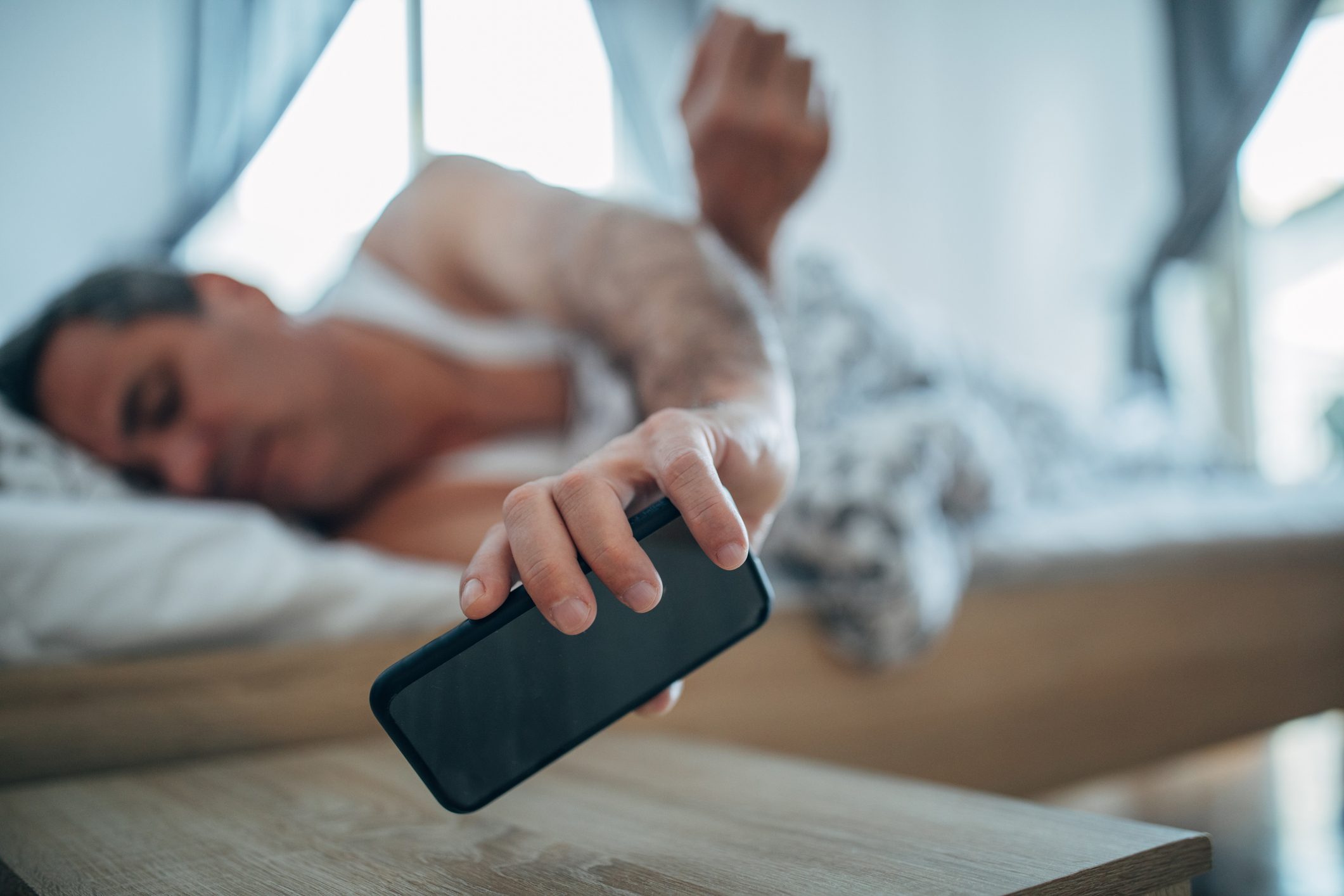 Man On Bed With Cell Phone