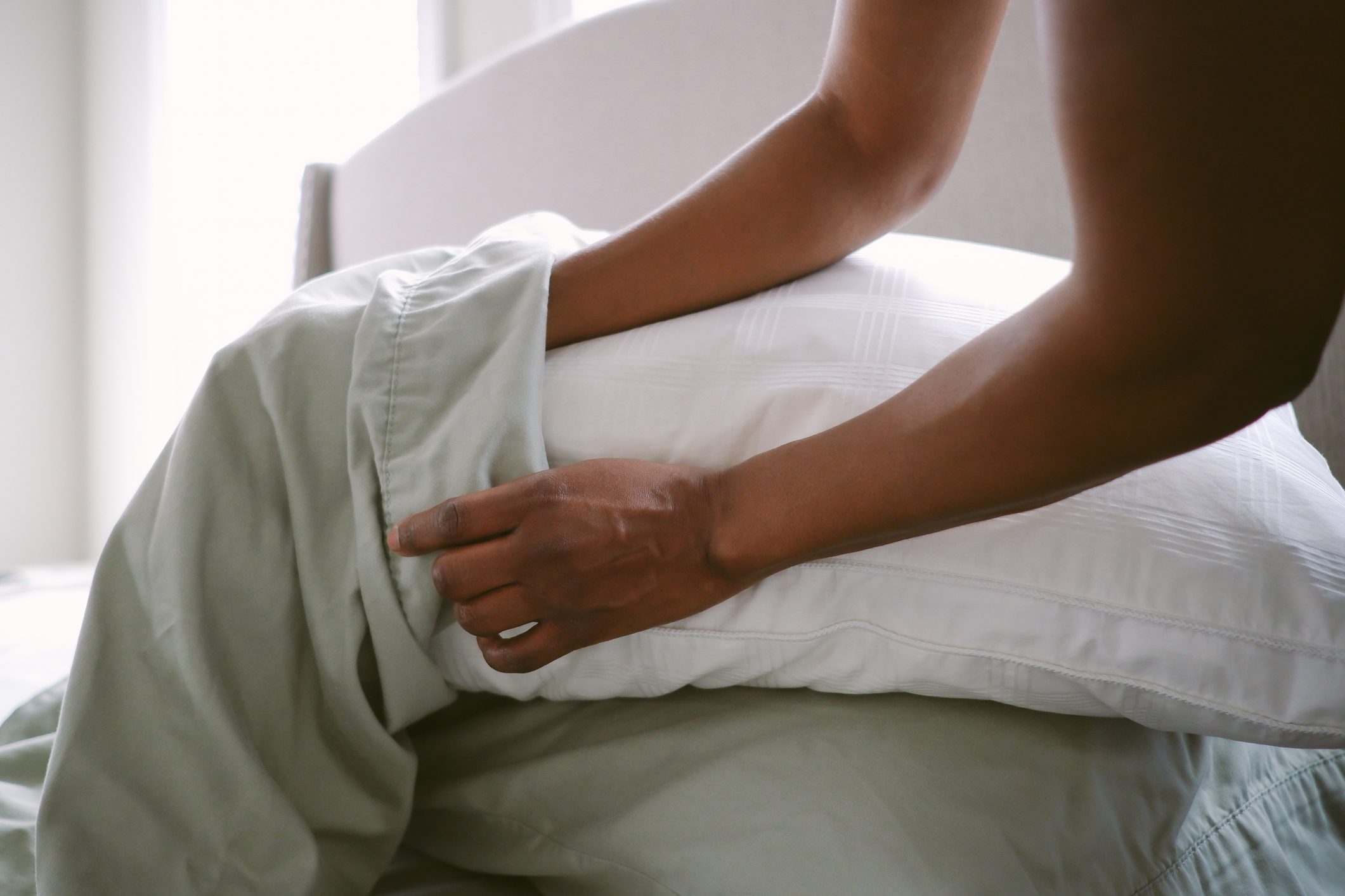 Woman Puts Pillow Into Pillowcase