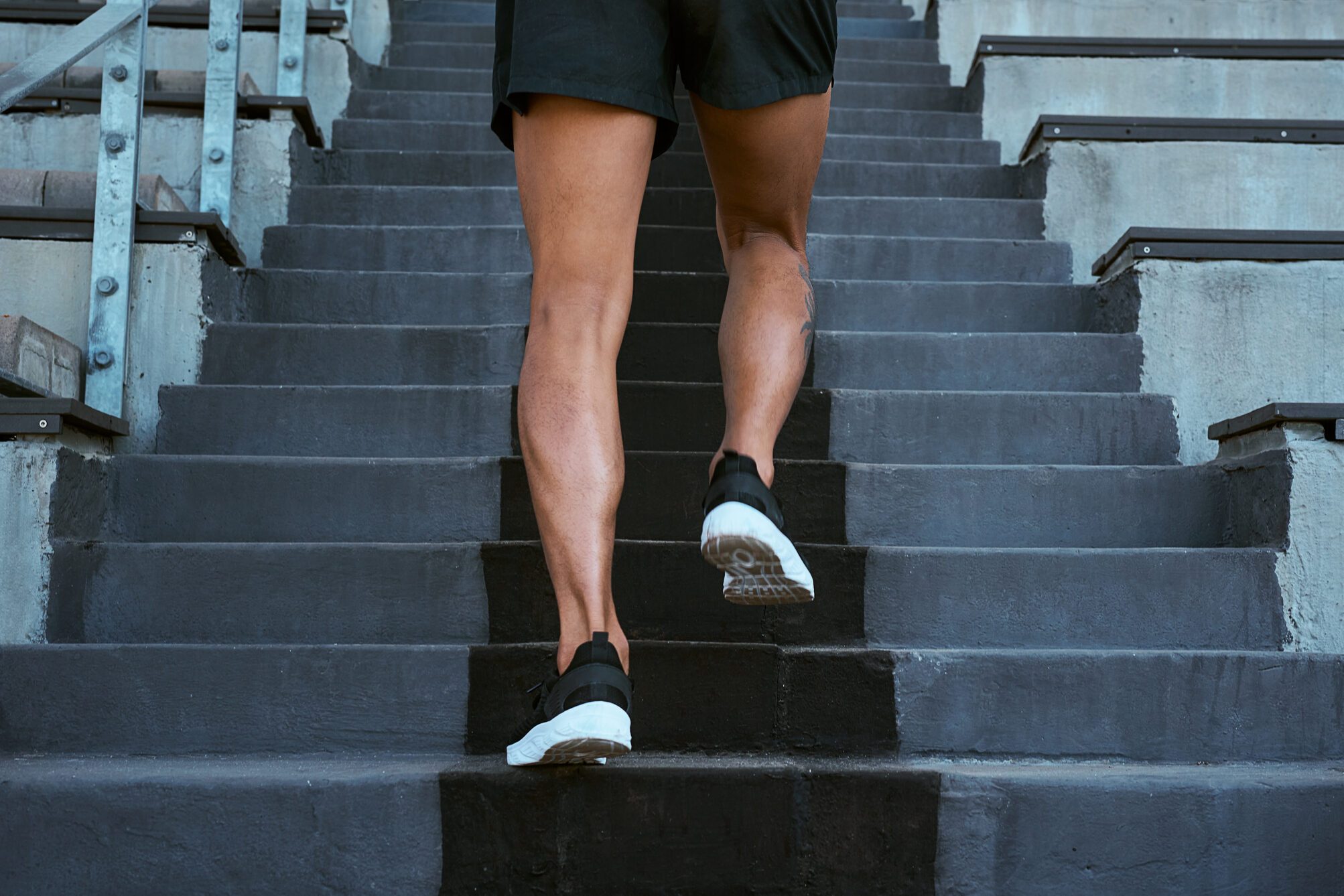 Shot of a man walking up the staircase at a track and field