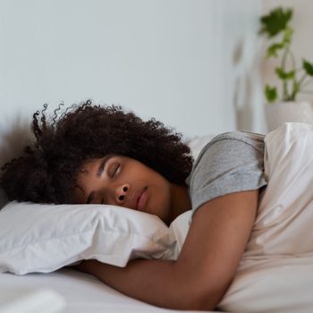 Young African woman sleeping in her bed in the morning