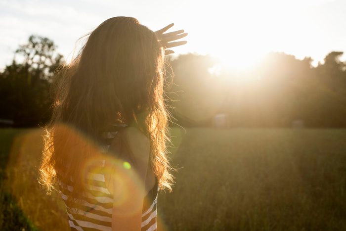 Woman shielding her eyes from sun