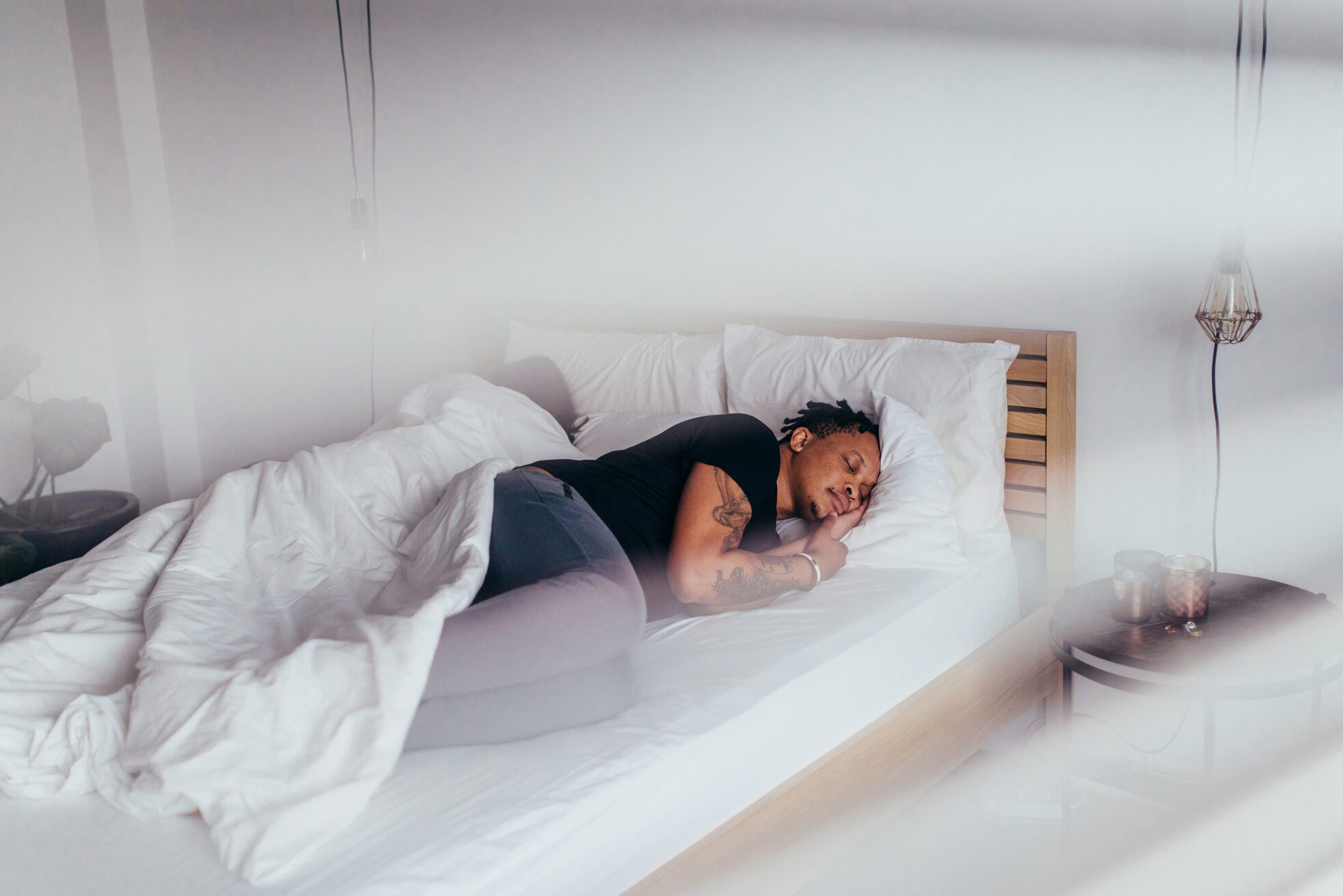 African man sleeping in bedroom with woman