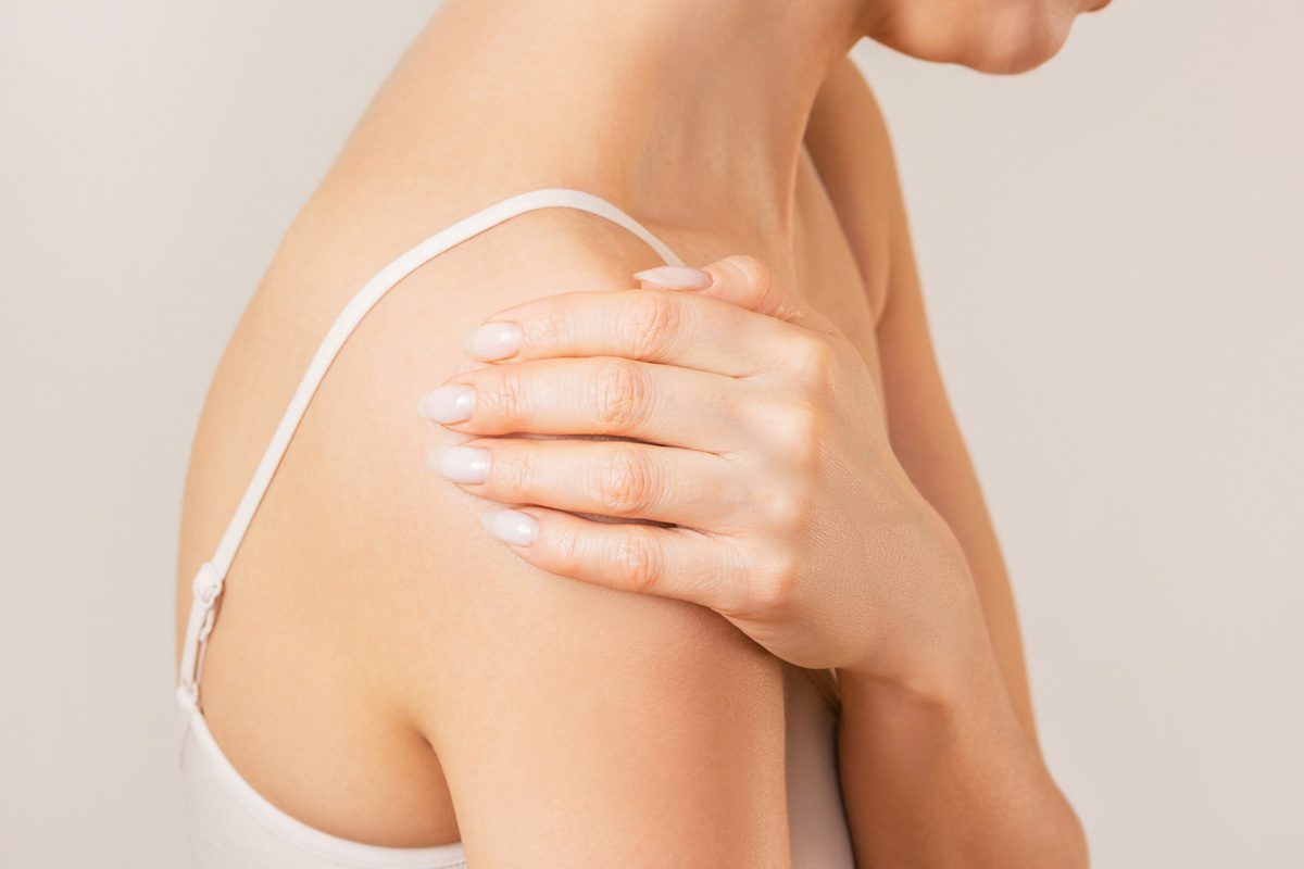 woman holding her arm