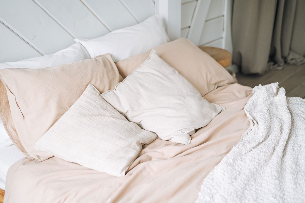 Beige Cotton Bed Linen Pillows Blanket On Wooden Eco Style Bed