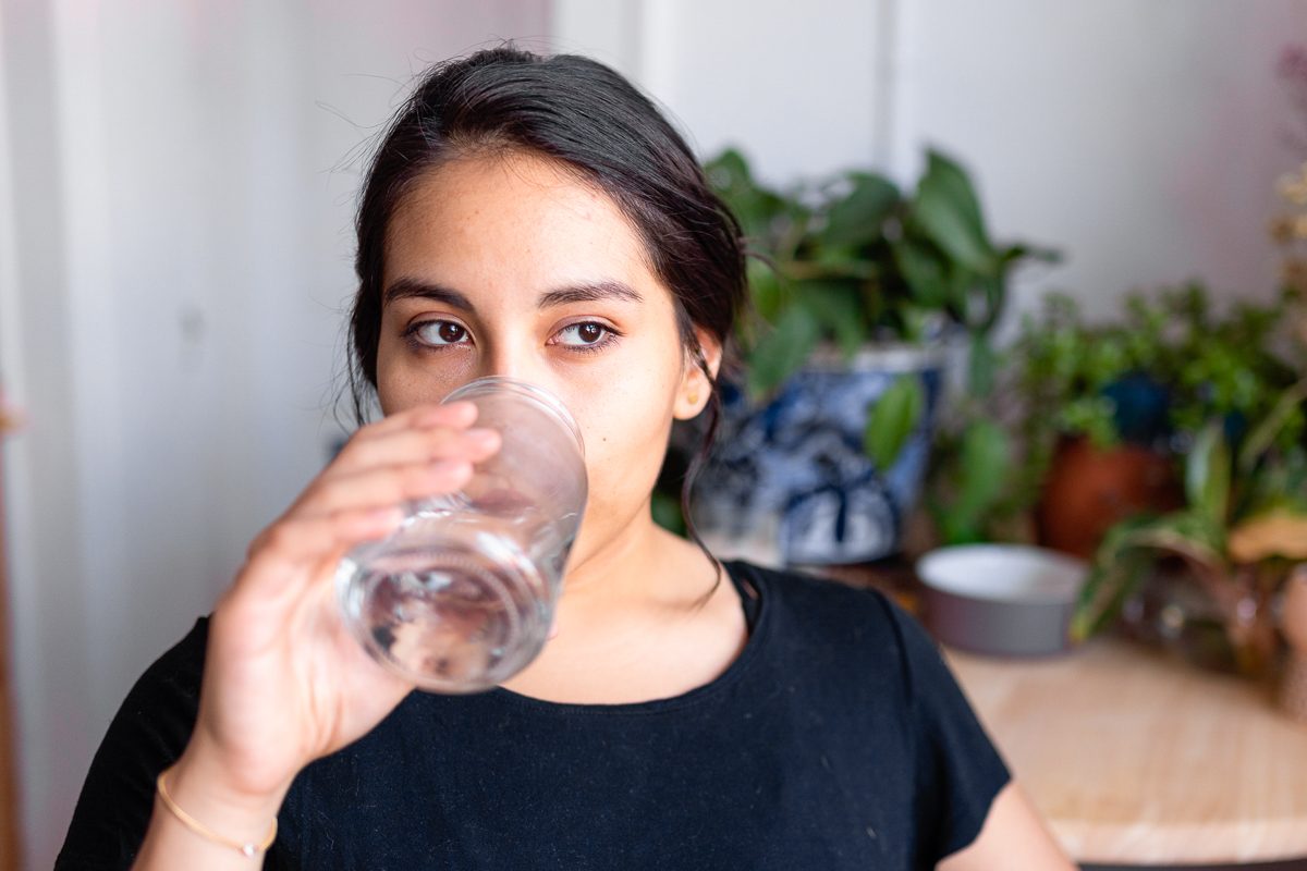woman drinking water at home