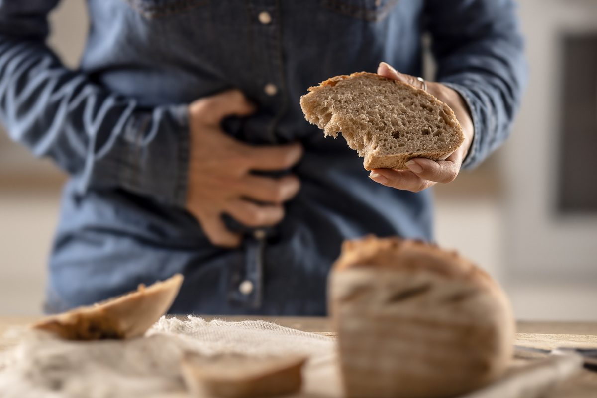person with gluten allergy clutching their stomach