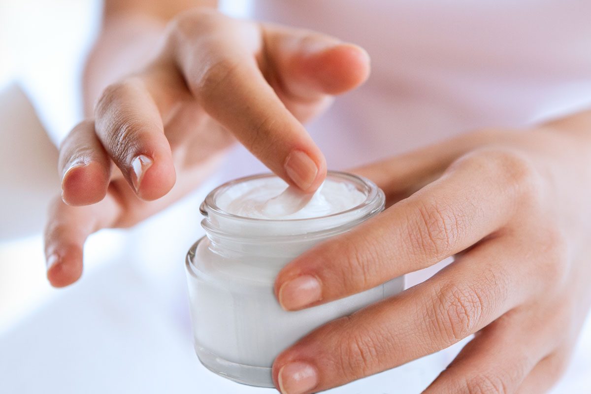 Womans Hand Touching On The Cream For Applying