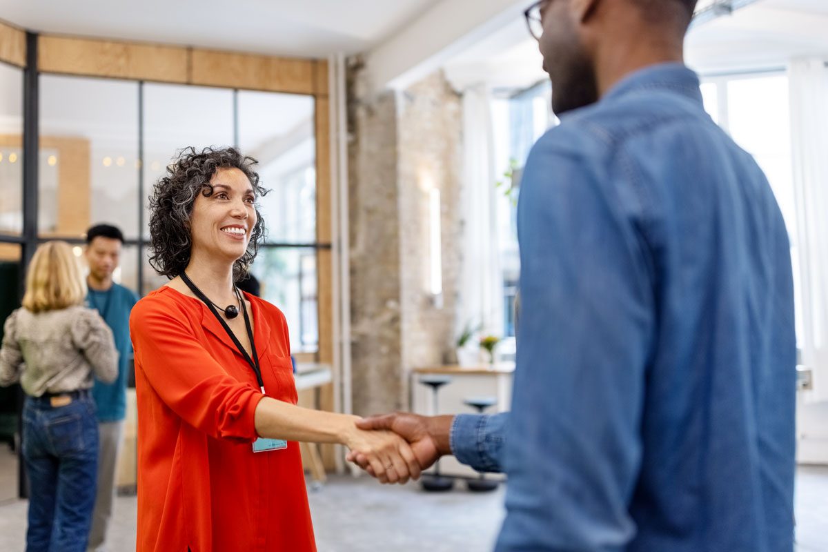 Man And Woman Standing In Office And Shaking Hands Gettyimages 1425190048 Ksedit
