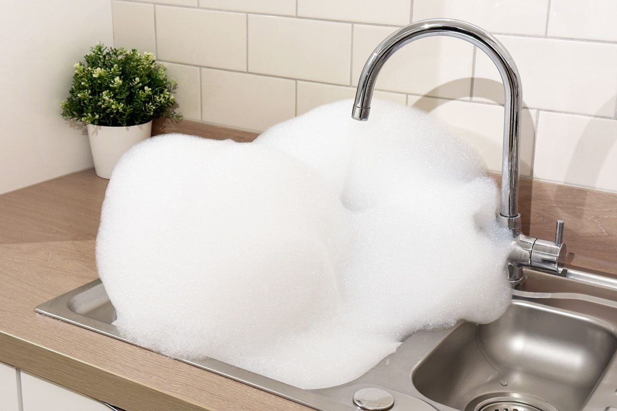Shampoo Bubbles Overflowing In The Kitchen Sink